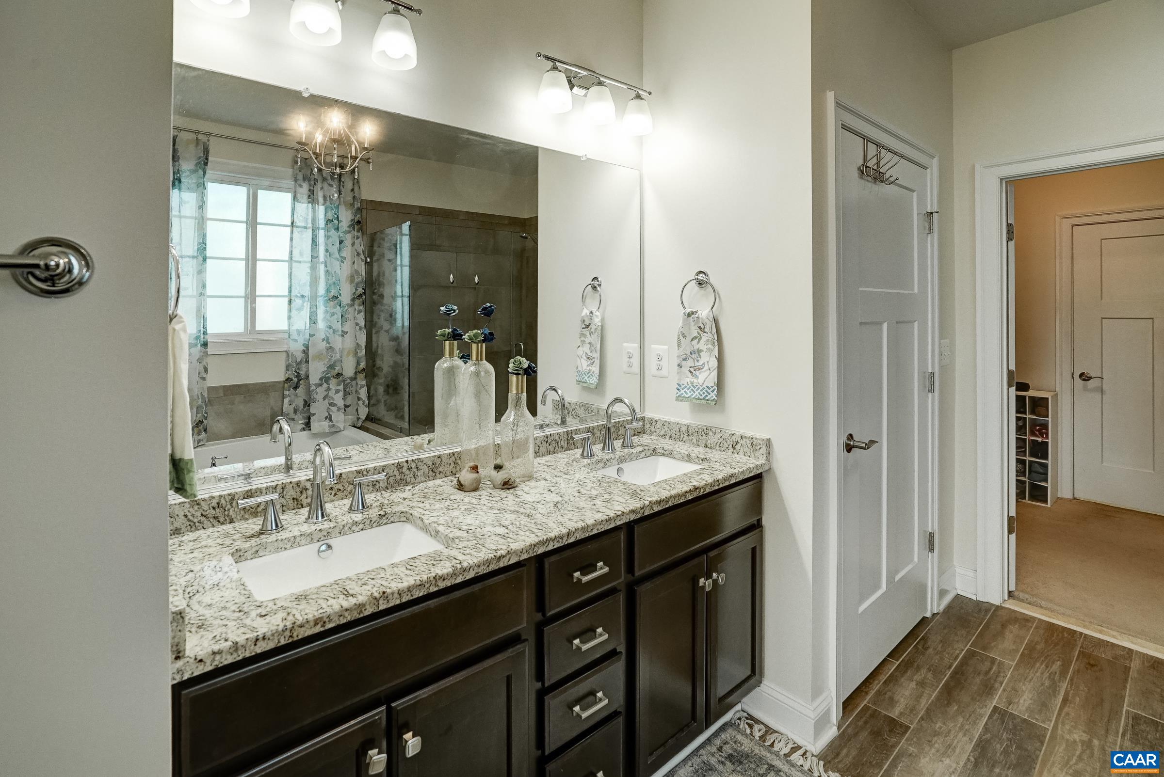7652 Birchwood Hill Road Crozet, VA 22932 - Photo 29 of 64 a bathroom with a granite countertop sink and a mirror