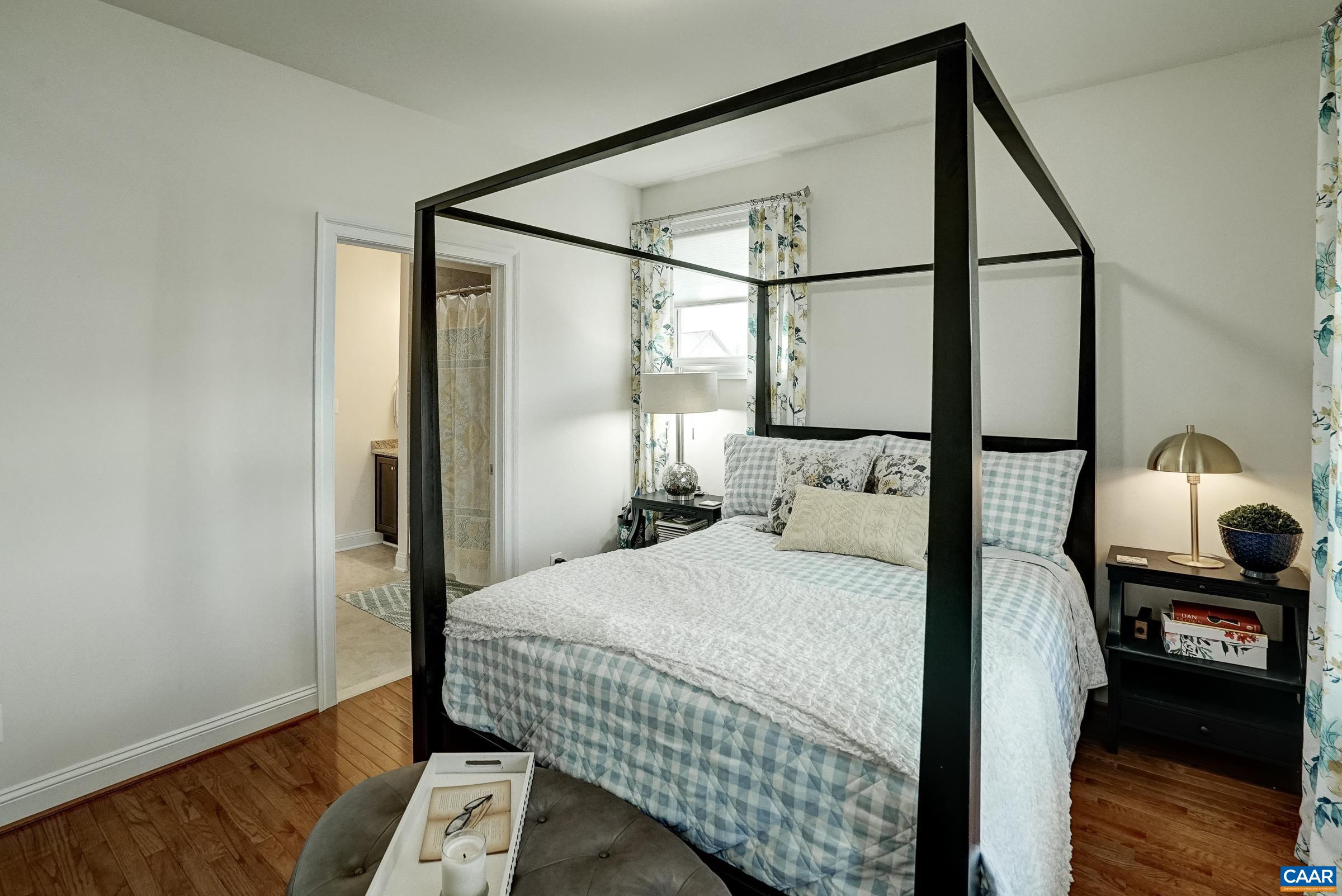 7652 Birchwood Hill Road Crozet, VA 22932 - Photo 35 of 64 a bedroom with a bed and wooden floor