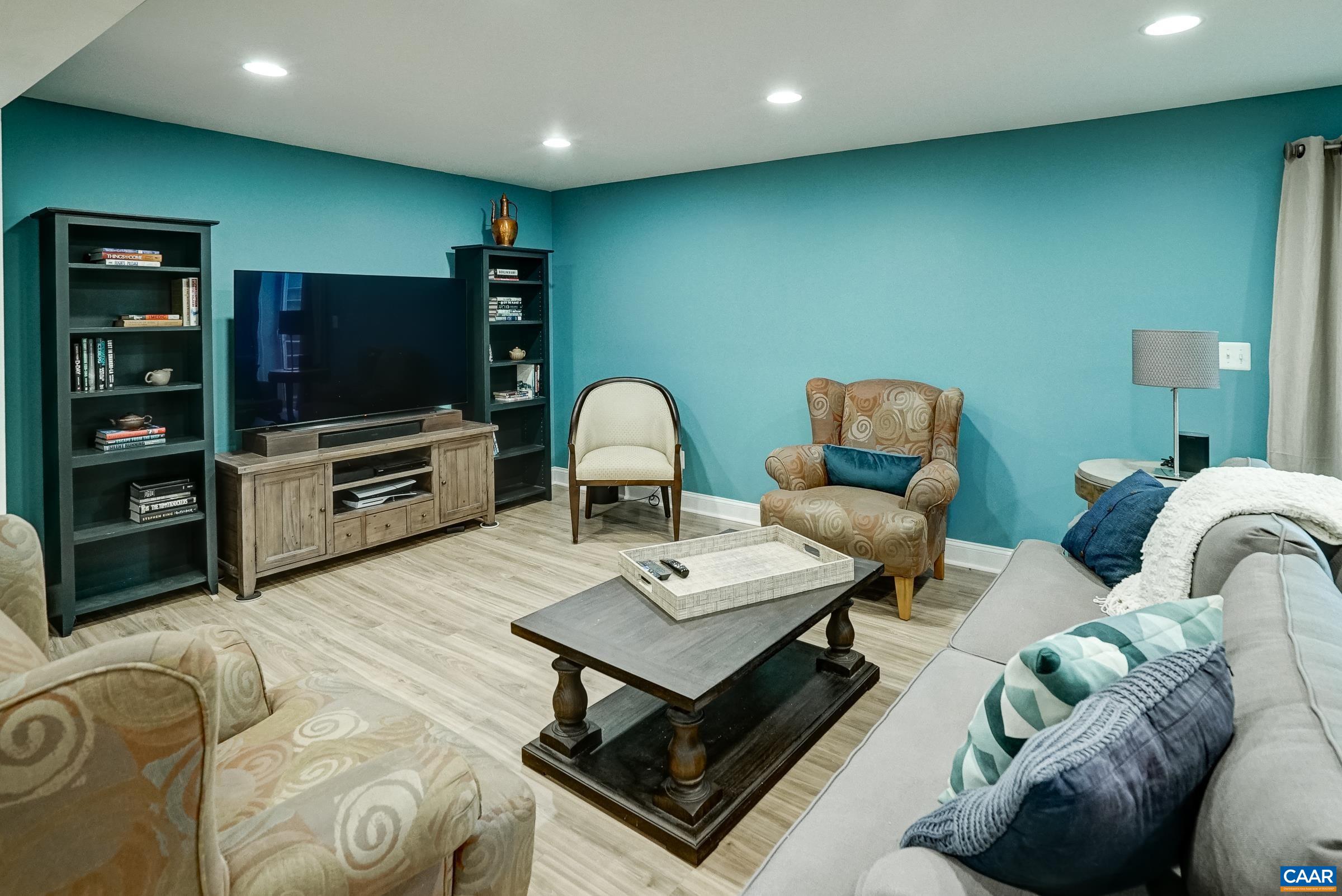 7652 Birchwood Hill Road Crozet, VA 22932 - Photo 49 of 64 a living room with furniture and a flat screen tv