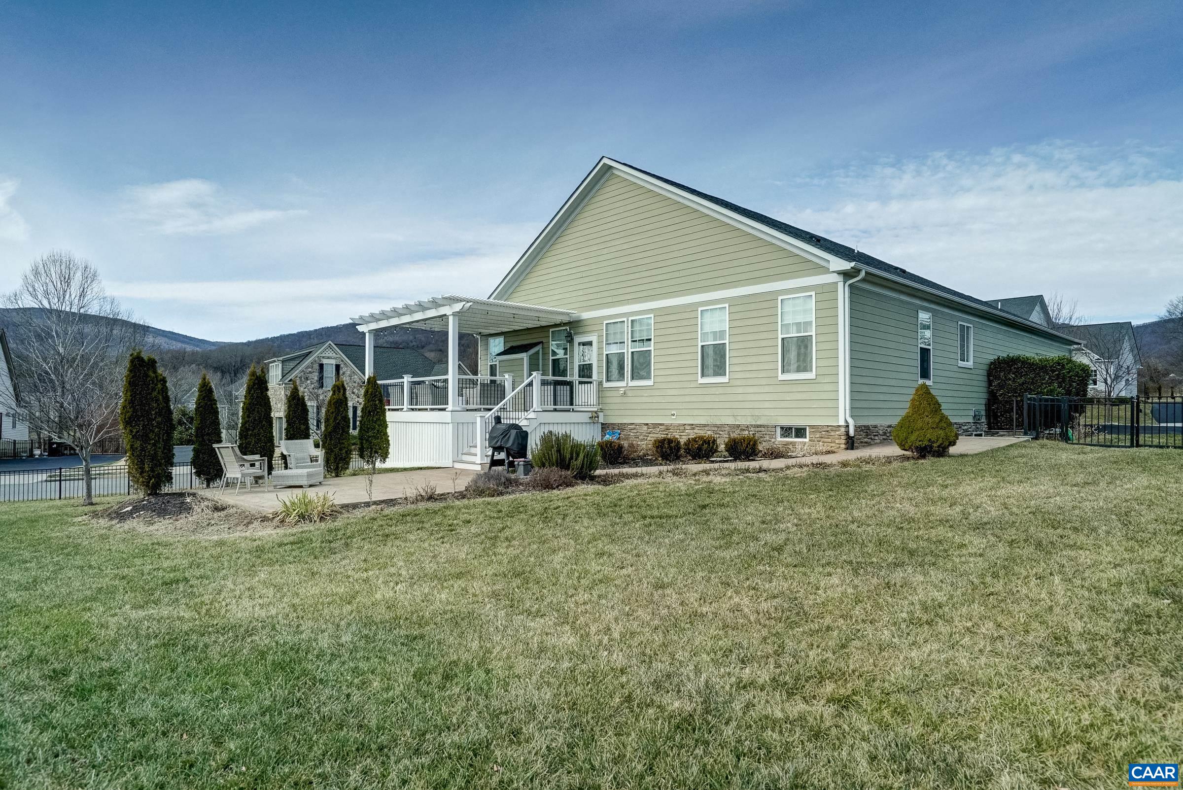 7652 Birchwood Hill Road Crozet, VA 22932 - Photo 60 of 64 a front view of a house with a yard and seating space