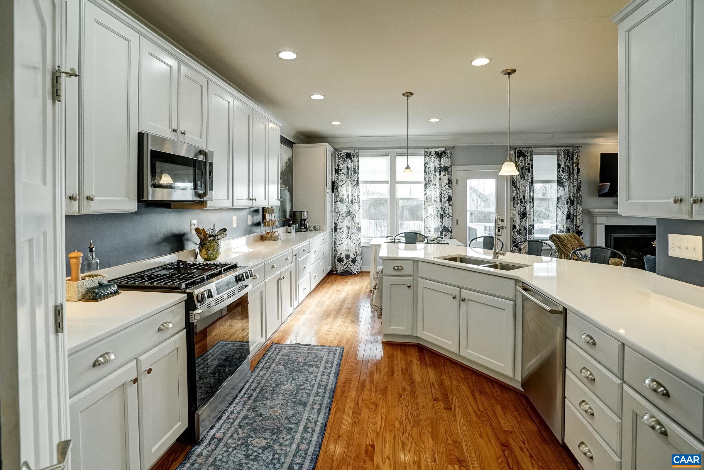 7652 Birchwood Hill Road Crozet, VA 22932 - Photo 10 of 64 a kitchen with stainless steel appliances granite countertop a stove a sink and a microwave