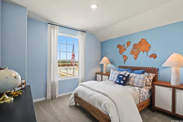 a bedroom with a bed and painting on the wall