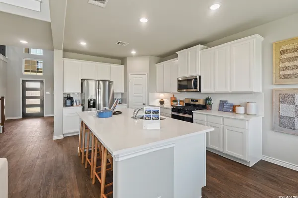 a kitchen with a sink a microwave and refrigerator