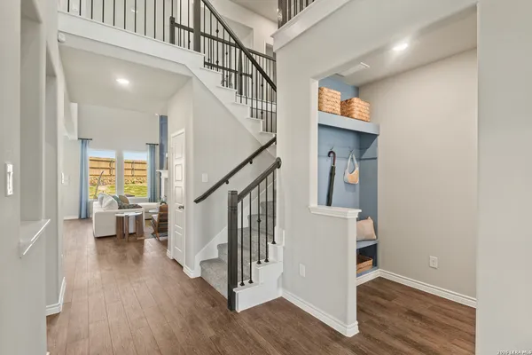 a kitchen with stainless steel appliances granite countertop a stove a sink dishwasher a dining table and chairs with wooden floor
