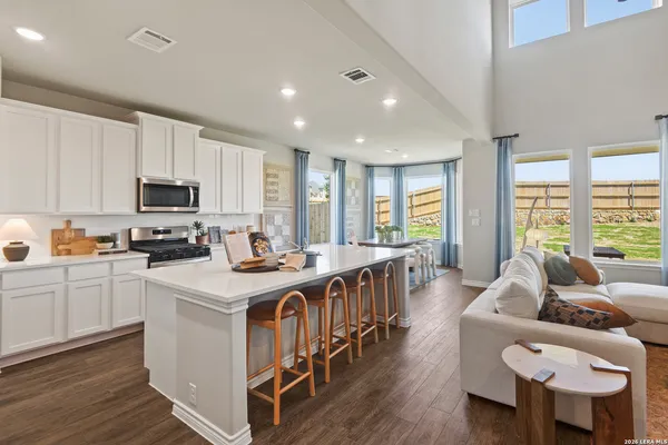 a kitchen with refrigerator a sink and cabinets