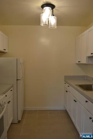 a room with a sink and cabinets