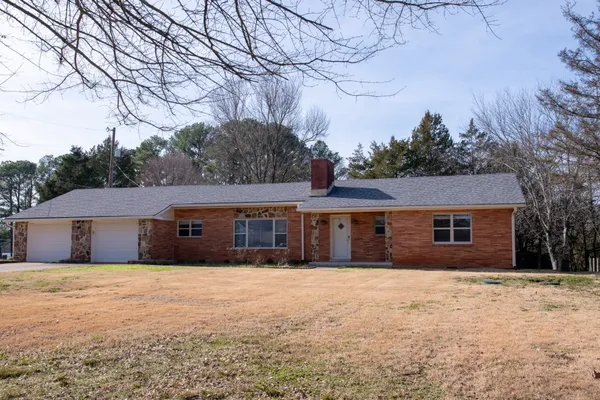 a front view of house with yard and trees