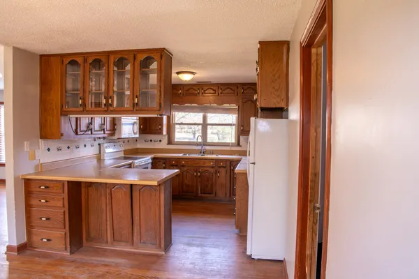 a kitchen with a sink cabinets and wooden floor