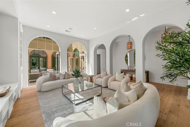 a living room with fireplace furniture and a large window