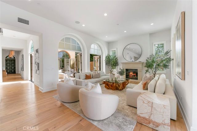 a view of a hallway with wooden floor and stairs
