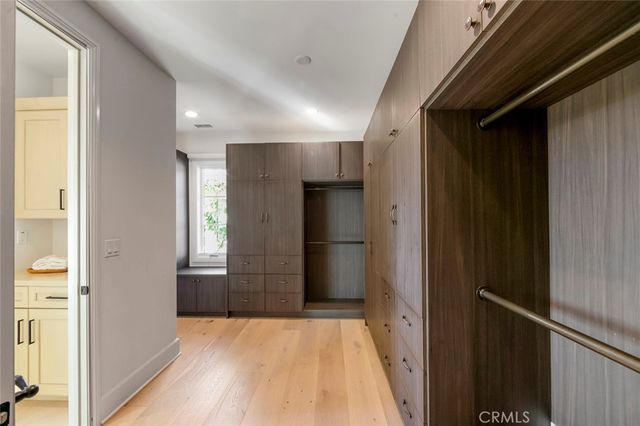 a living room with furniture potted plant and a large window