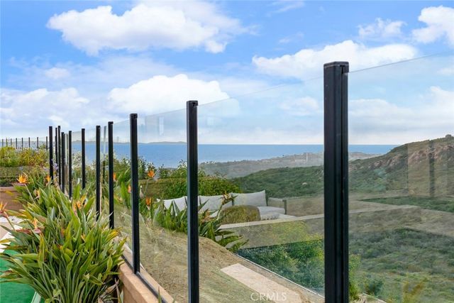 a view of a porch with furniture and a yard