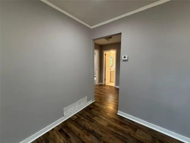a view of an empty room and wooden floor