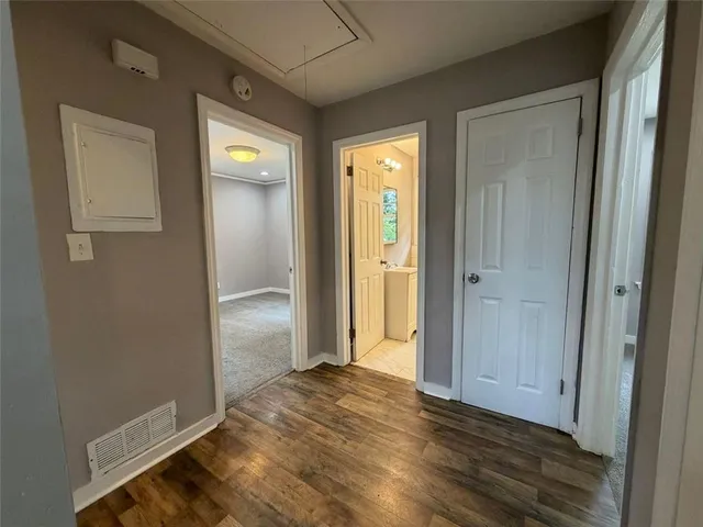 an empty room with wooden floor and closet