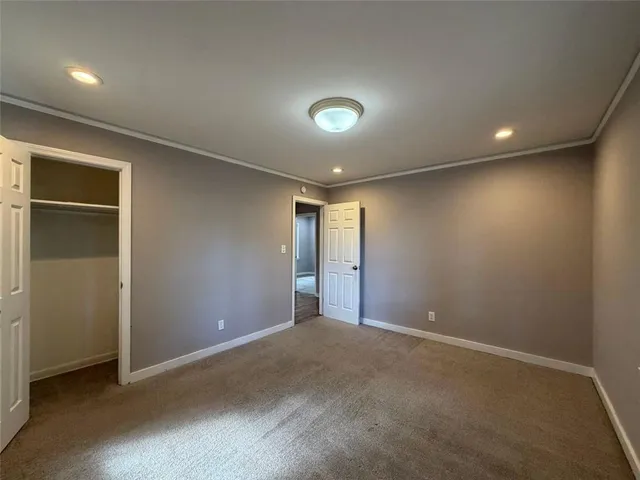 an empty room with closet area