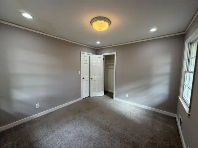 an empty room with windows and entrance