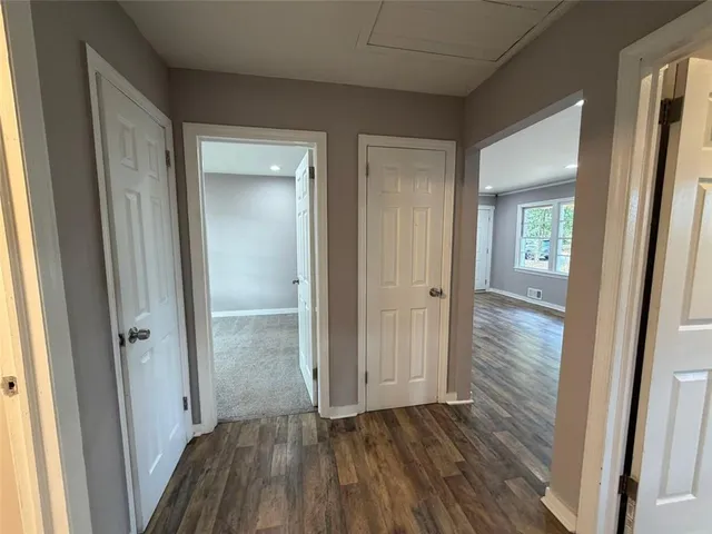 a view of a hallway with wooden floor
