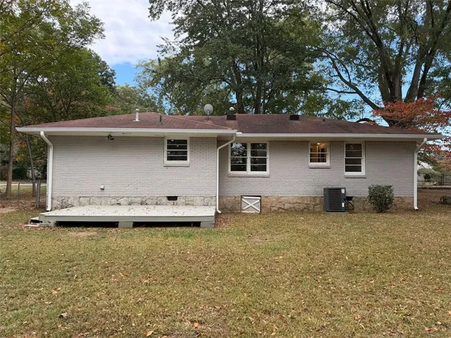 a backyard of a house with table and chairs
