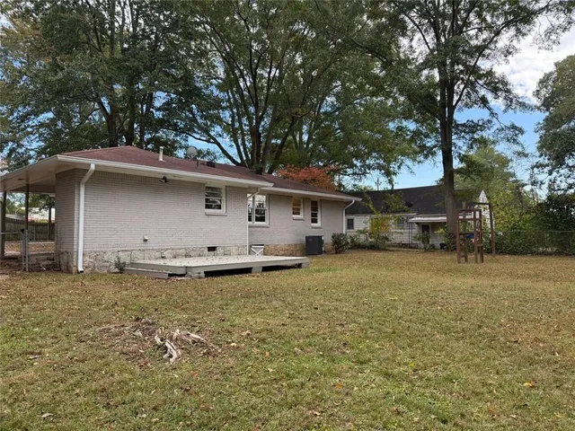 a front view of house with yard and trees