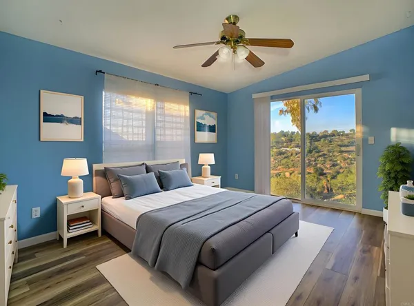 a bedroom with a large bed and a large window