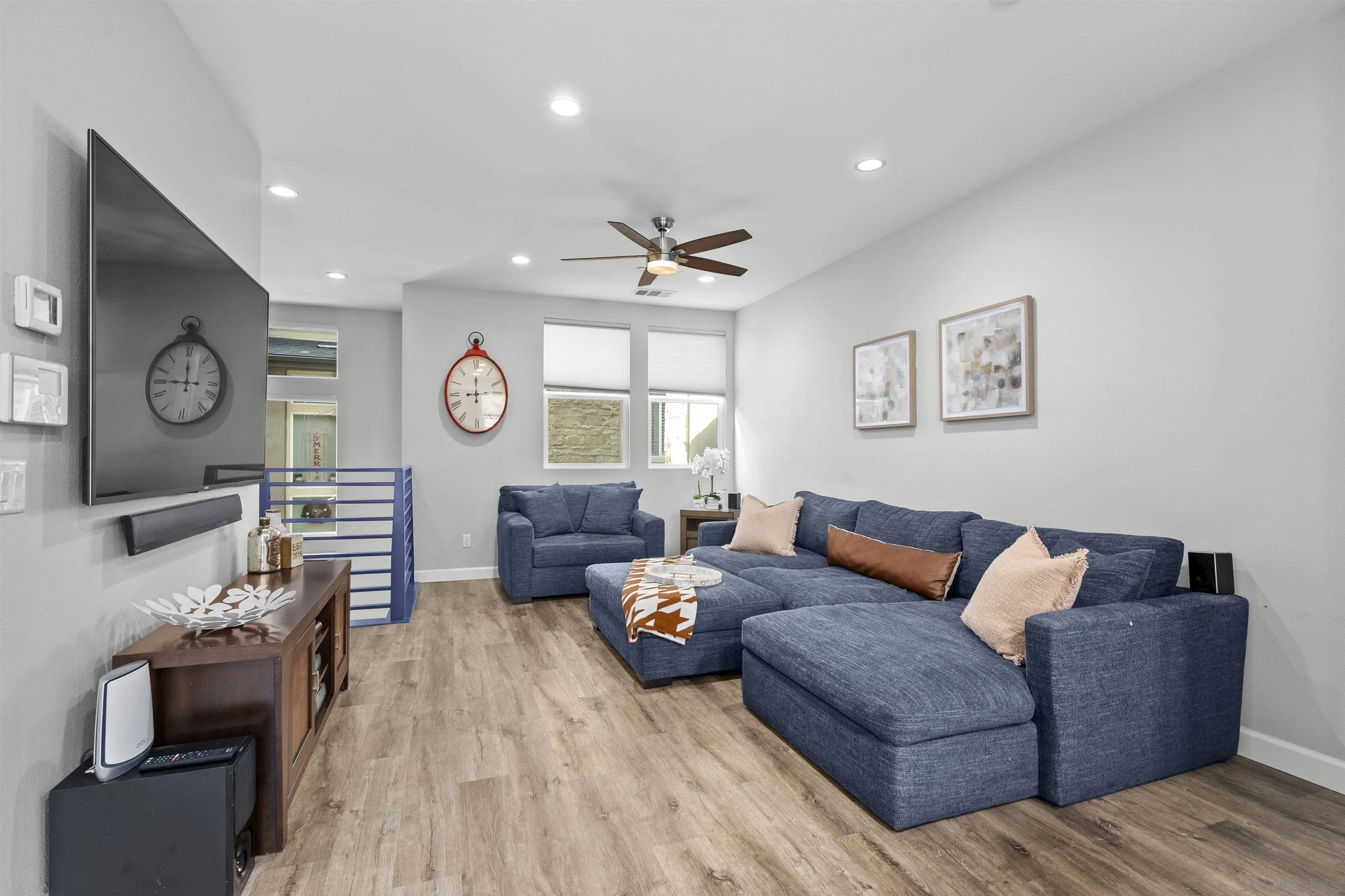 7834 Inception Way San Diego, CA 92108 - Photo 13 of 62 a living room with furniture a clock and a ceiling fan