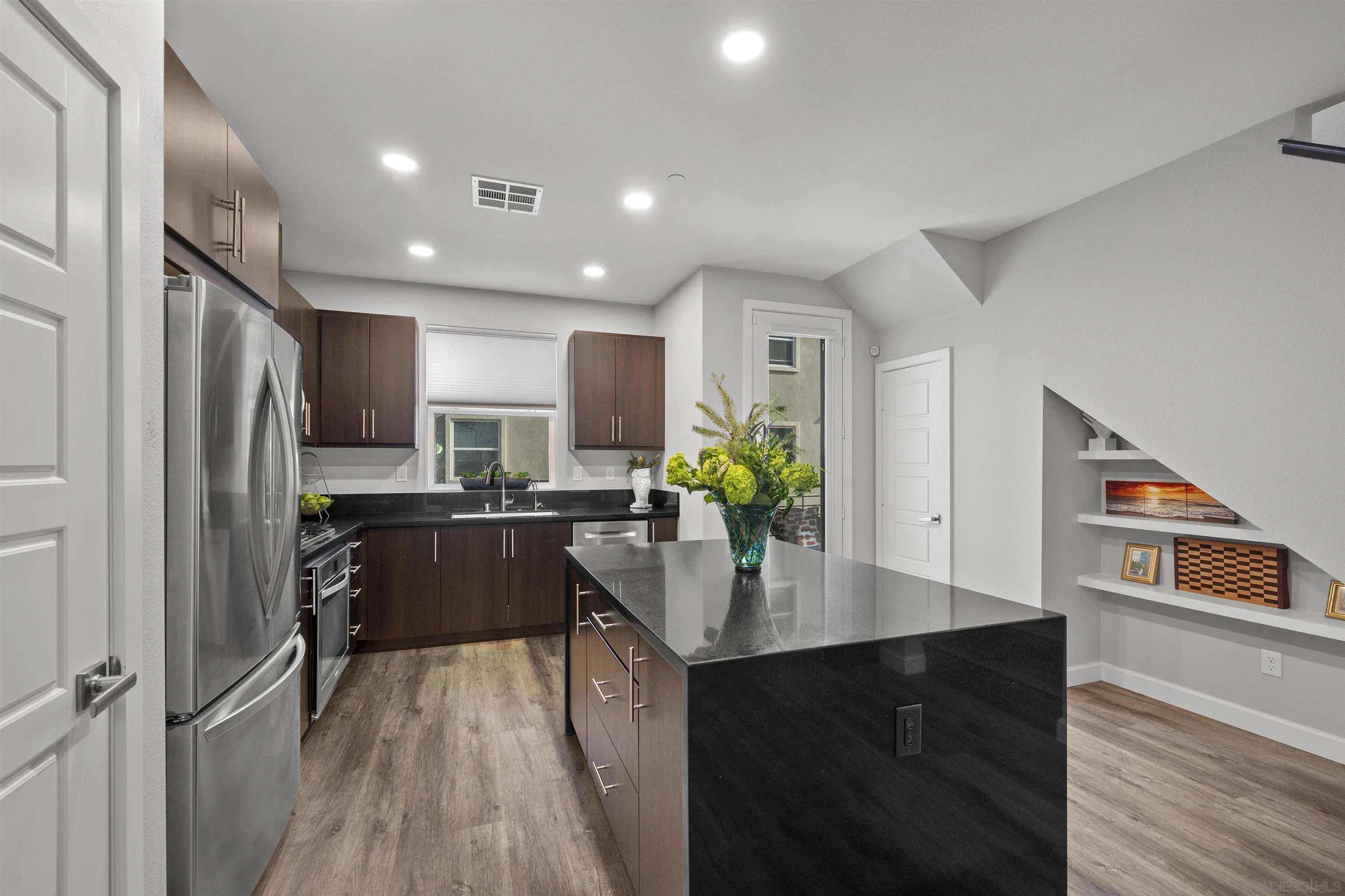 7834 Inception Way San Diego, CA 92108 - Photo 14 of 62 a kitchen with refrigerator cabinets and wooden floor