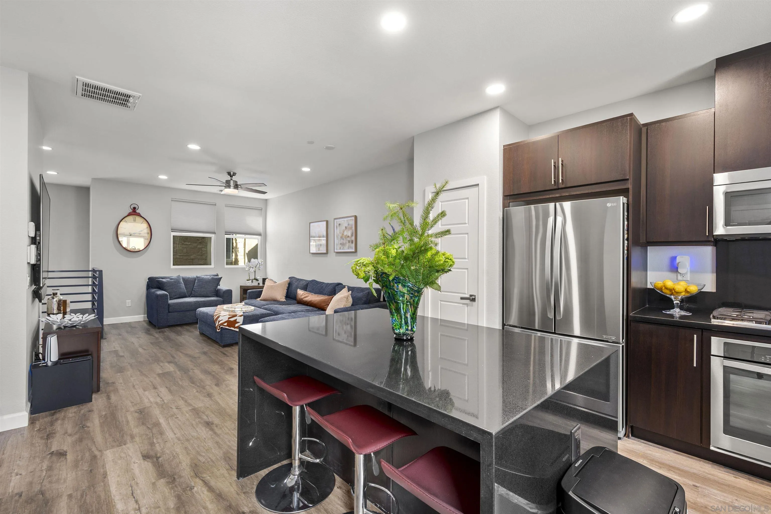 7834 Inception Way San Diego, CA 92108 - Photo 15 of 62 a kitchen with stainless steel appliances granite countertop a refrigerator dining table and chairs