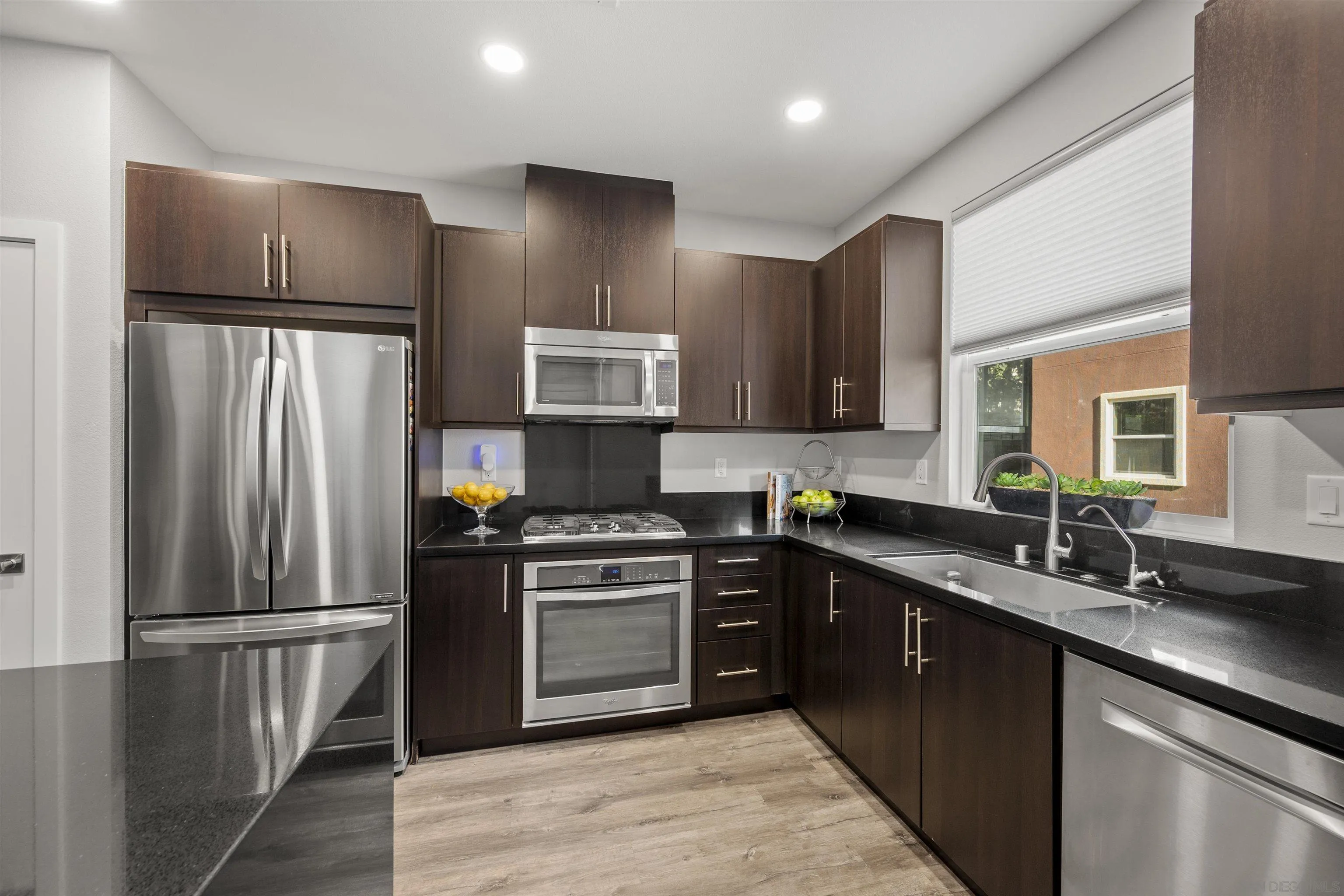 7834 Inception Way San Diego, CA 92108 - Photo 21 of 62 a kitchen with stainless steel appliances granite countertop a refrigerator a sink a stove a microwave and island