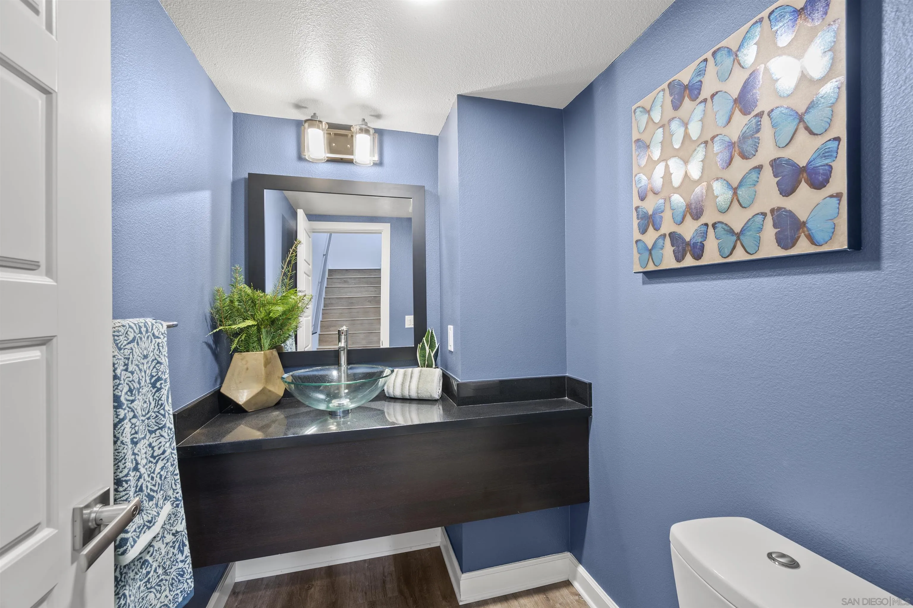 7834 Inception Way San Diego, CA 92108 - Photo 24 of 62 a dining room with table lamp and wooden floor