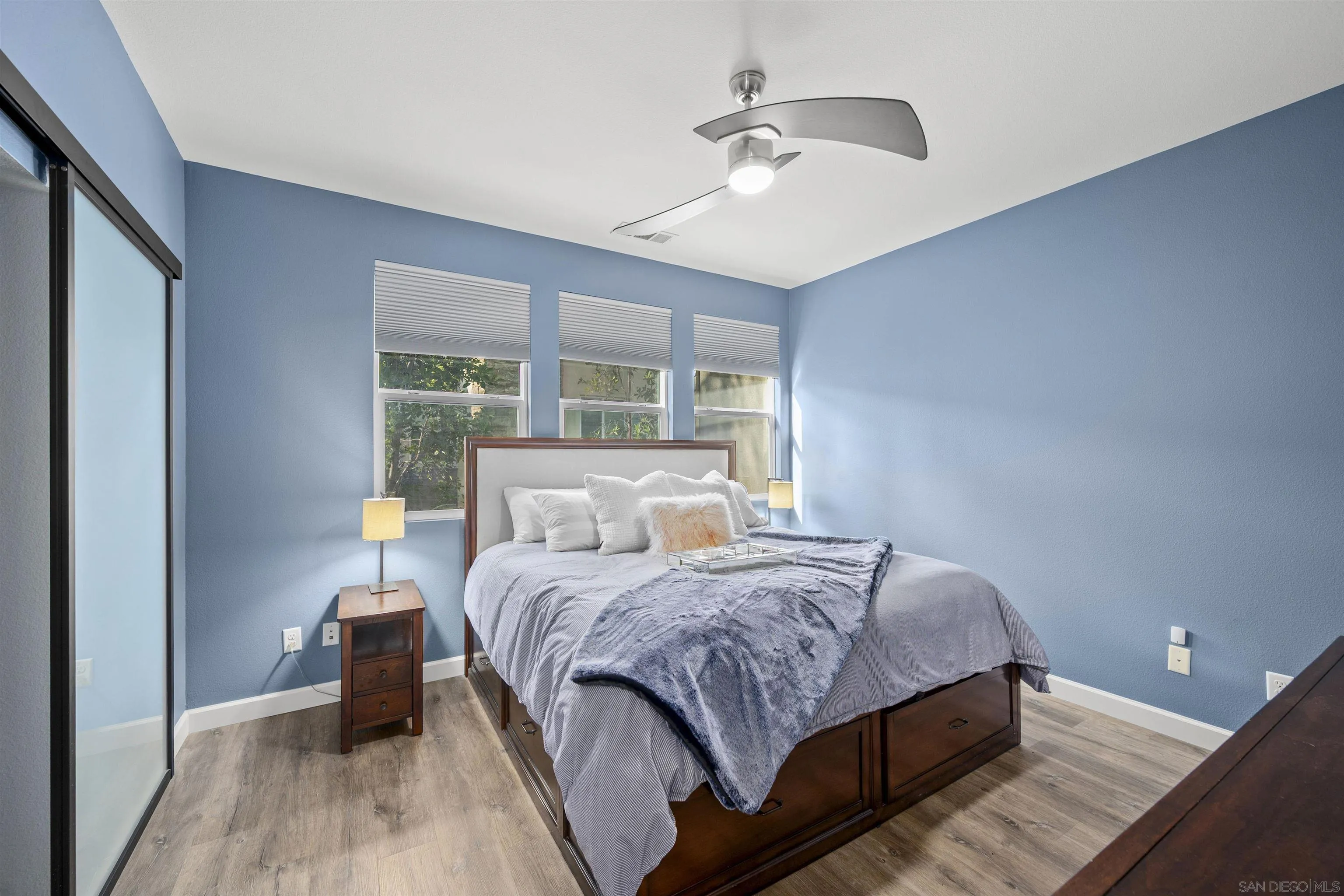 7834 Inception Way San Diego, CA 92108 - Photo 26 of 62 a bedroom with a bed and wooden floor