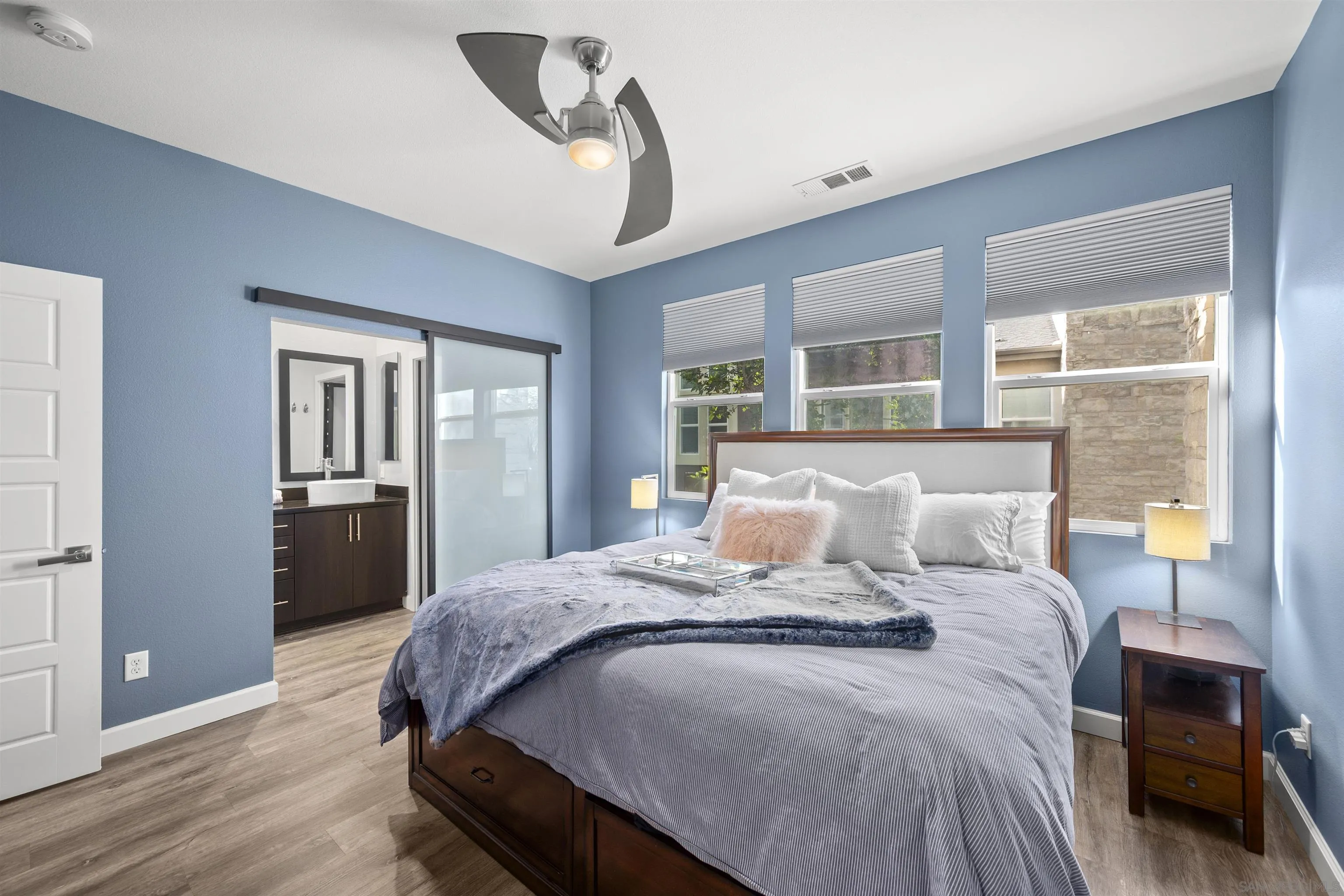 7834 Inception Way San Diego, CA 92108 - Photo 27 of 62 a bedroom with a large bed and a chandelier