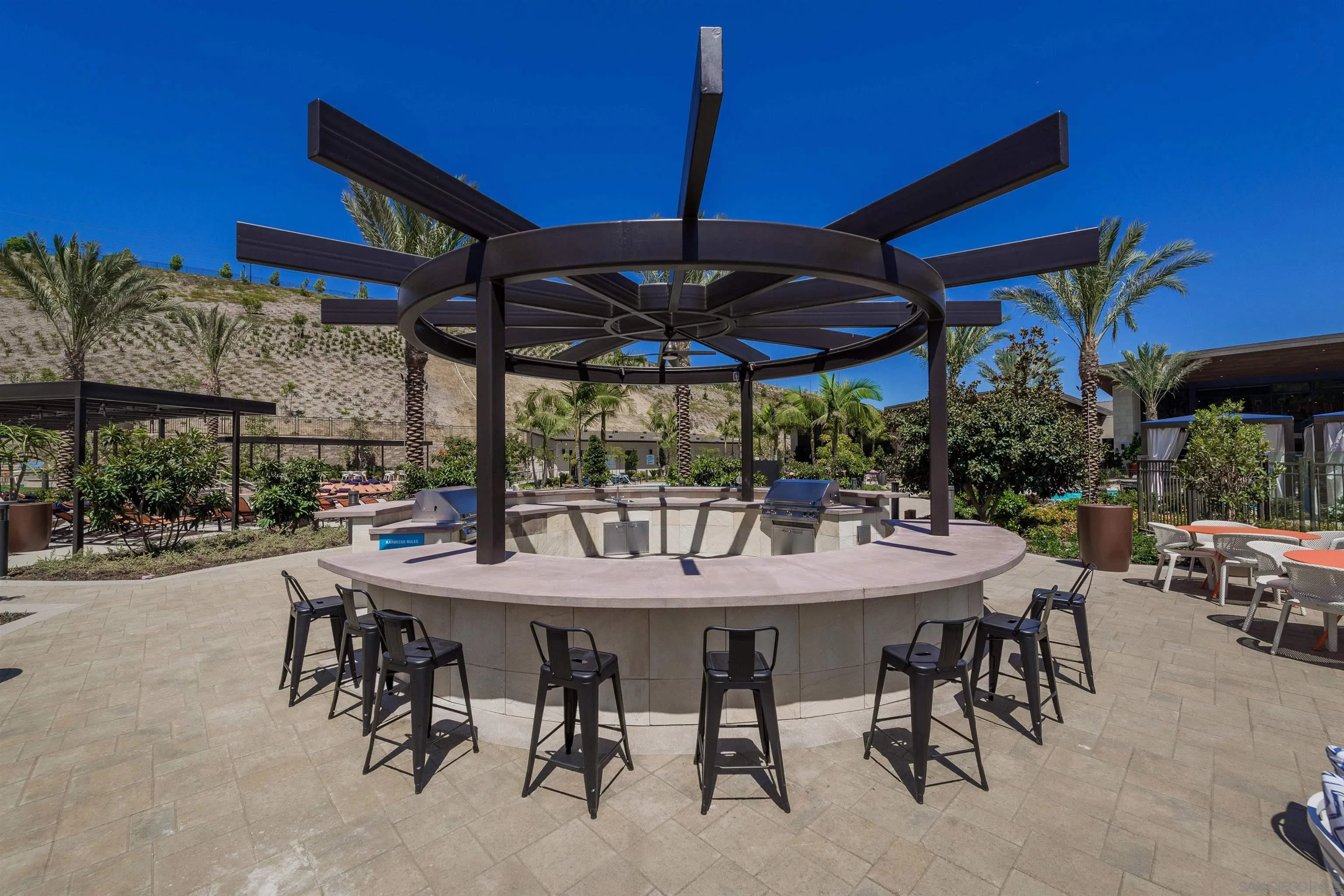 7834 Inception Way San Diego, CA 92108 - Photo 53 of 62 a view of patio with table and chairs under an umbrella