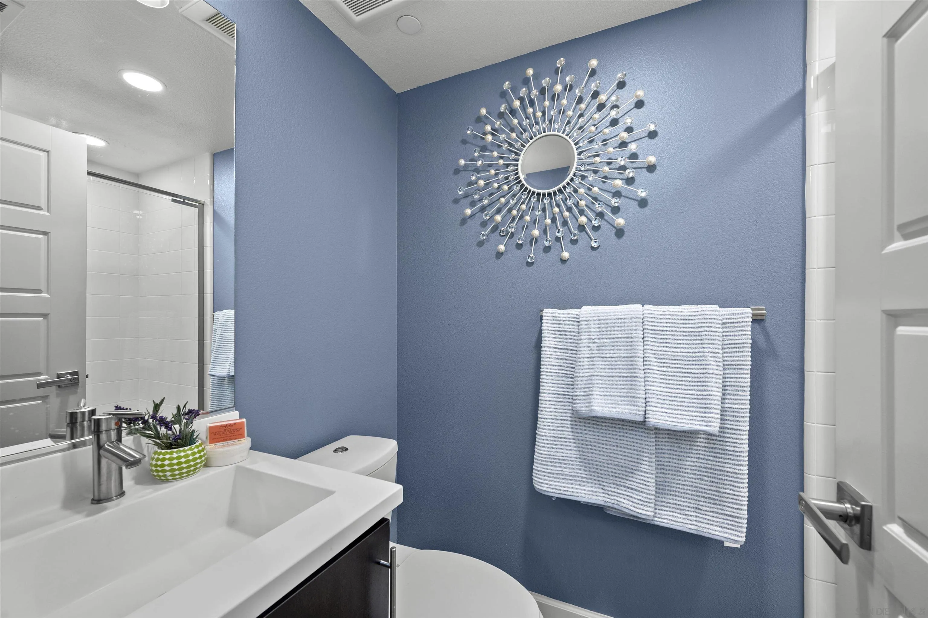 7834 Inception Way San Diego, CA 92108 - Photo 8 of 62 a bathroom with a sink toilet and mirror