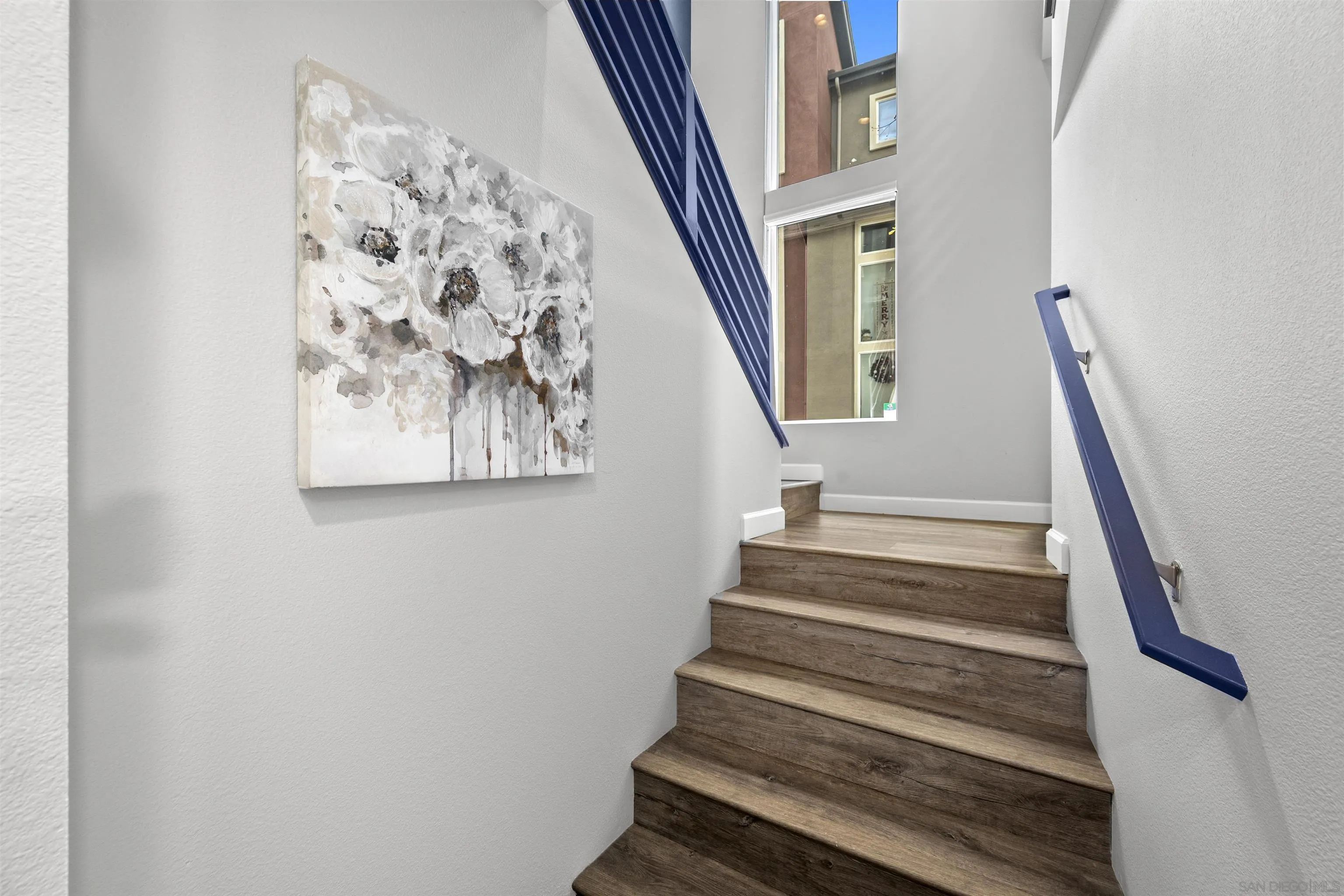 7834 Inception Way San Diego, CA 92108 - Photo 9 of 62 a view of staircase with wooden floor and a window