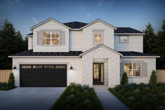 a front view of a house with yard and green space