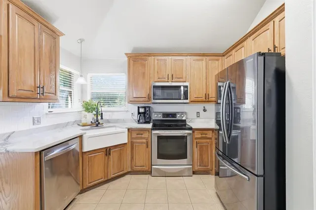 a bedroom with a bed and a flat tv screen on dresser