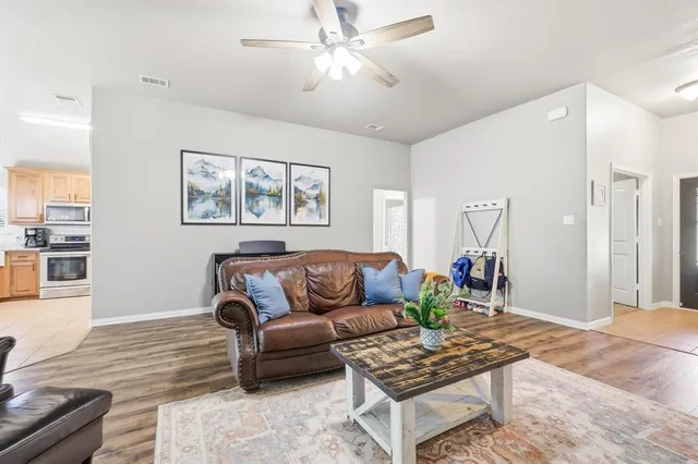 a living room with furniture a rug and a chandelier