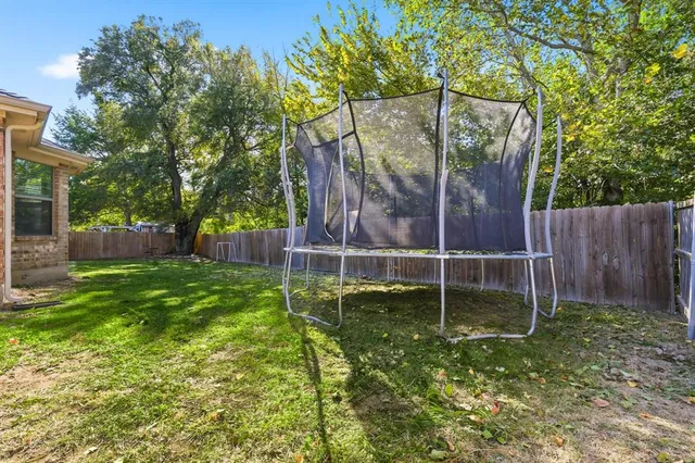 a swimming pool with outdoor seating and yard
