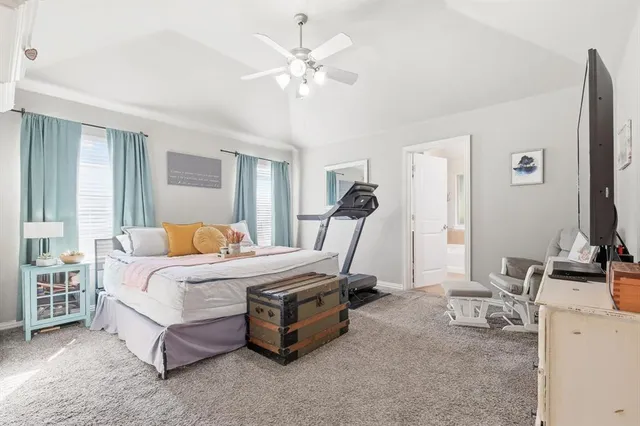 a bedroom with a bed a couch and a chandelier