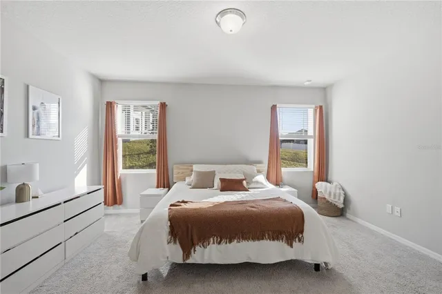 a bedroom with a bed and a large window