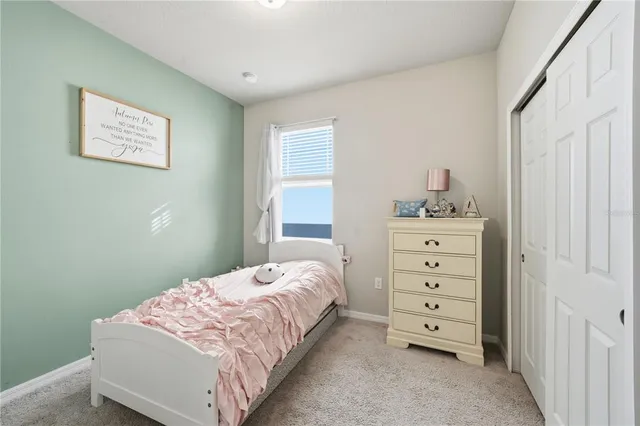 a bedroom with a bed and a dresser