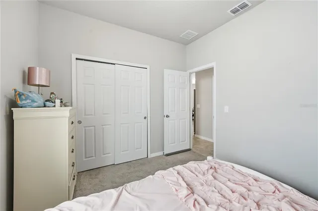 a bedroom with a bed and a sink