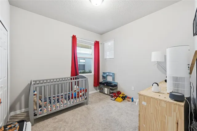 a bedroom with furniture and baby crib