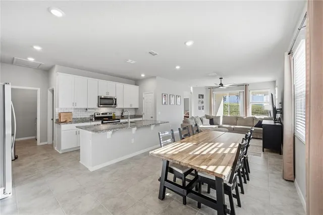 a large kitchen with a table and chairs