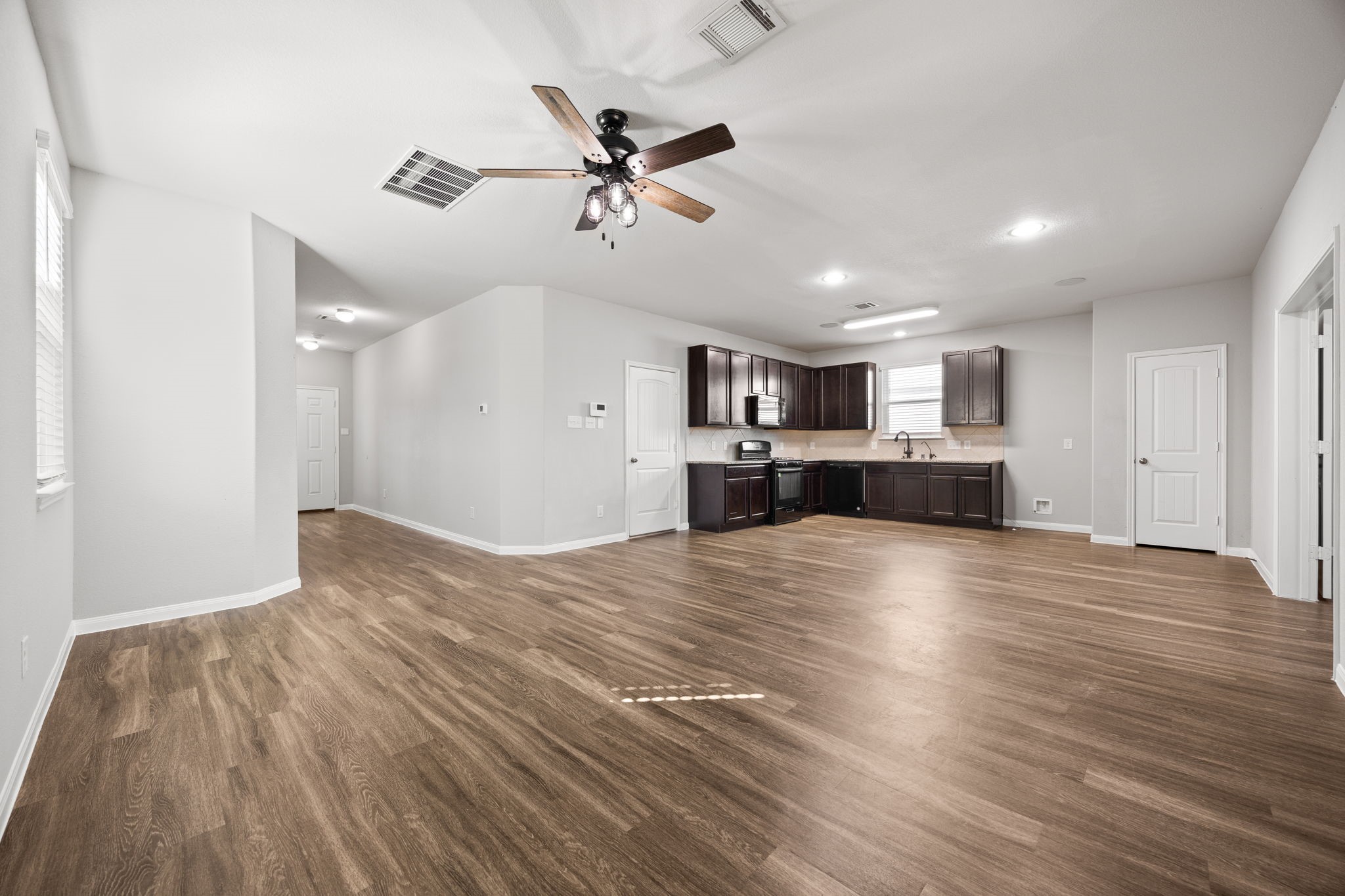 18606 Lansdowne Stream Path Katy, TX 77449 - Photo 16 of 39 a view of empty room with wooden floor and ceiling fan