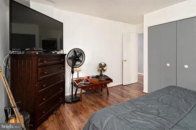 a bedroom with a bed and a television