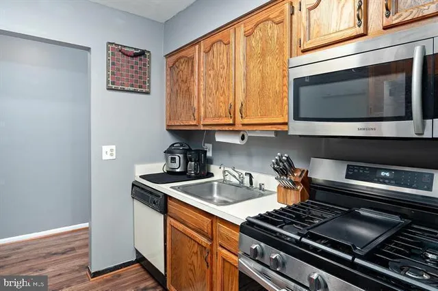 a kitchen with stainless steel appliances granite countertop a stove and a microwave