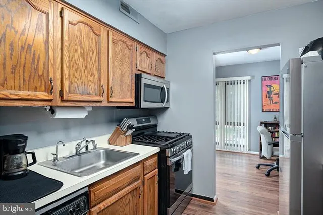 a kitchen with sink cabinets and appliances