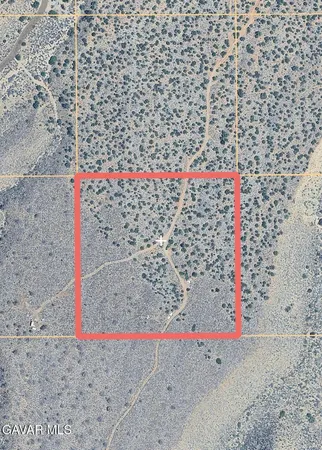 a small white building with a bench and shower