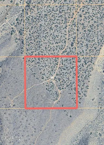 a small white building with a bench and shower